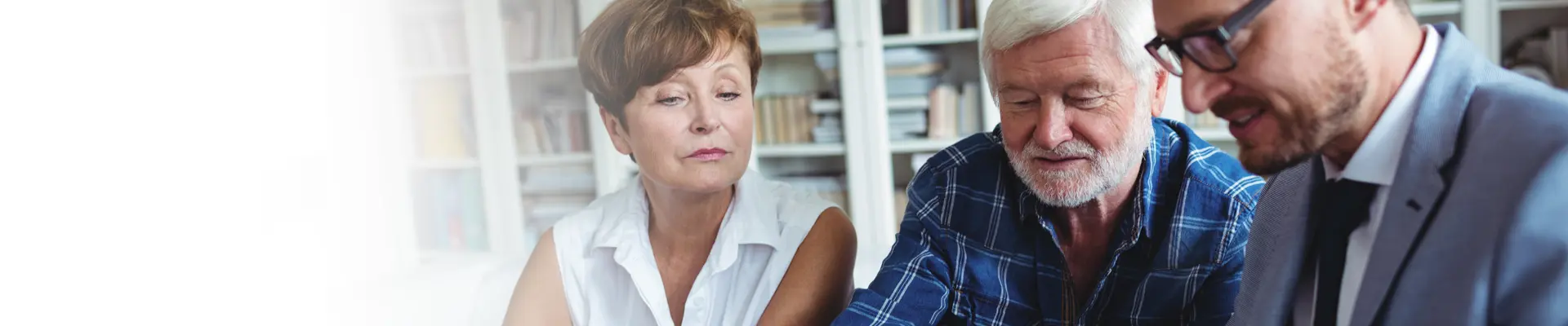 a couple completing paperwork with a businessman