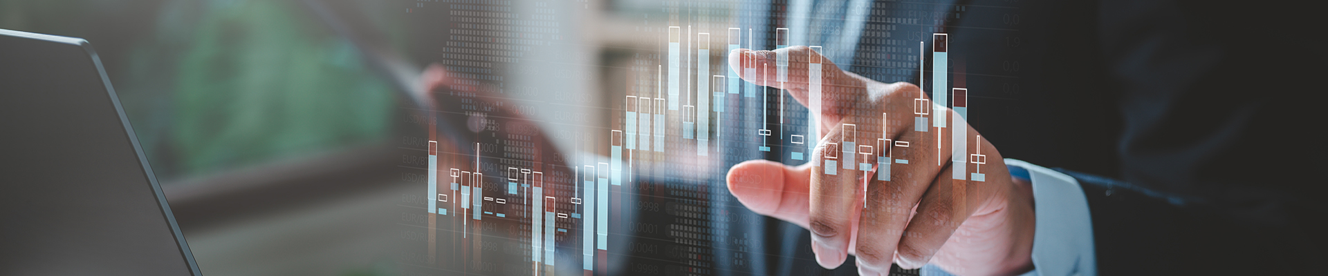 Person at their desk pointing to a graph
