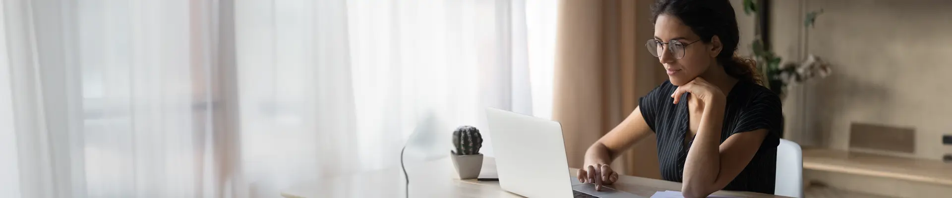Woman on laptop on her desk at home
