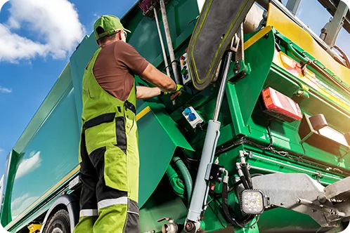 trash man standing next to trash truck