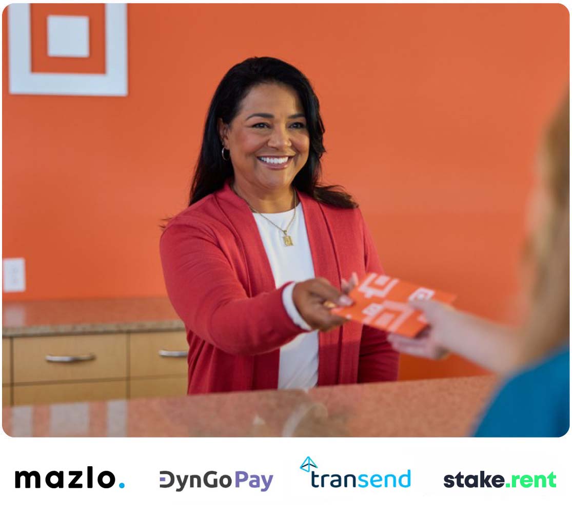 Universal banker smiling as she hands customer envelope