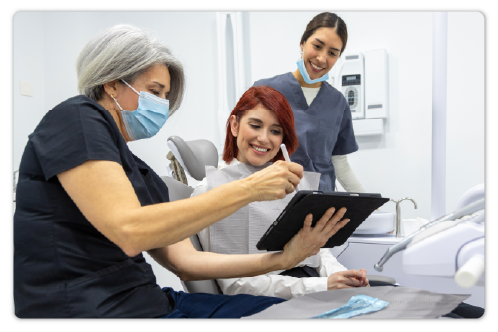 Medical professionals and a patient looking at a tablet