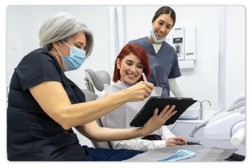 Medical professionals and a patient looking at a tablet