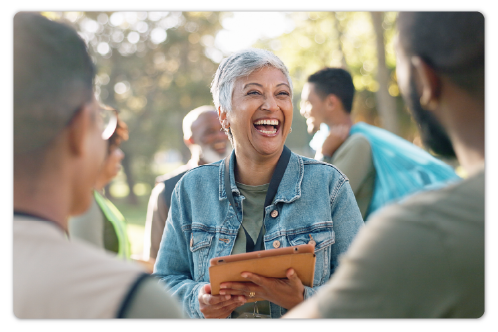 A woman with a tablet smiling
