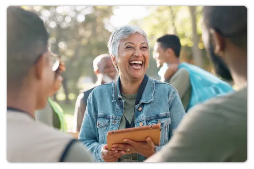 A woman with a tablet smiling