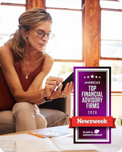 woman looking at Midland wealth features on phone with Newsweek award overlaid
