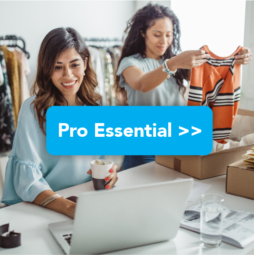 One business woman packing clothing to ship to customer and another business woman looking at her computer
