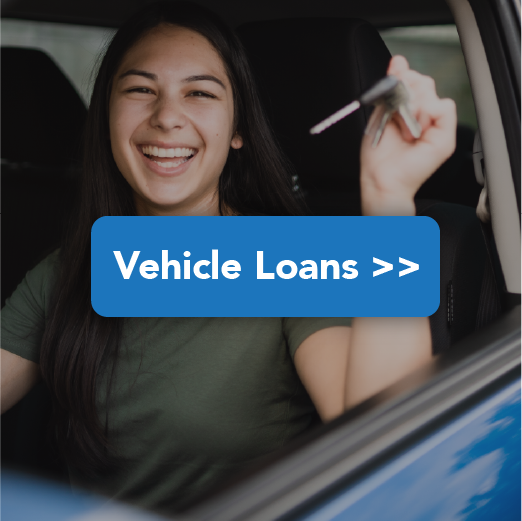 Young woman smiling while she hold up the keys to her new car