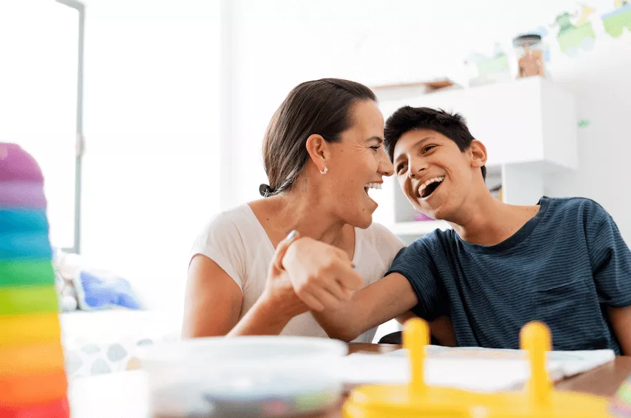 Mother and special needs son laughing and smiling
