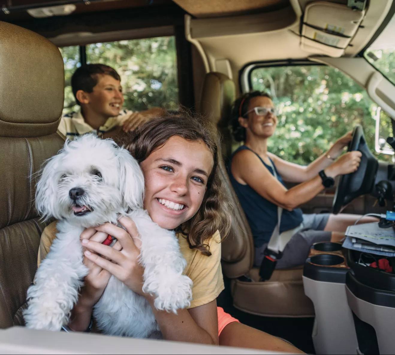 family riding in RV with their dog