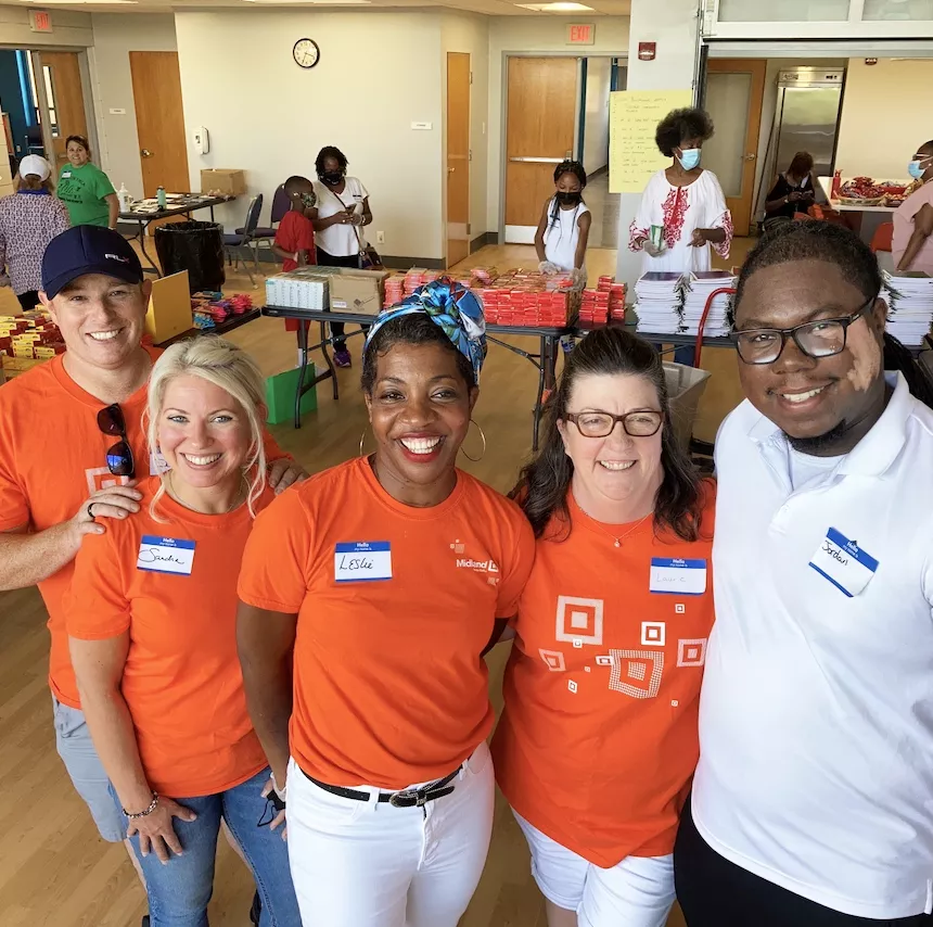 diverse group of Midland employees smiling while at a charity event