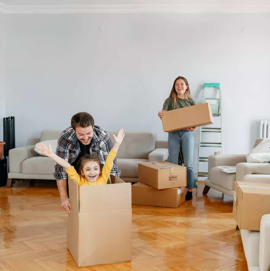 family having fun while moving in a new home
