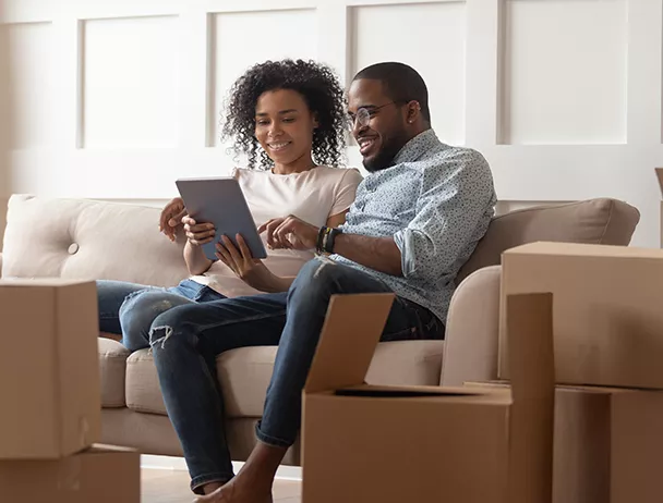 Couple using a tablet to learn more about Home Improvement Loans from Midland