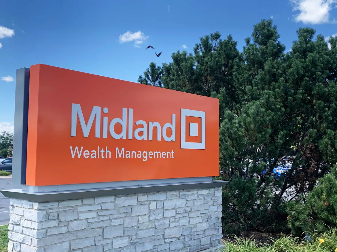 midland wealth management sign against blue sky background