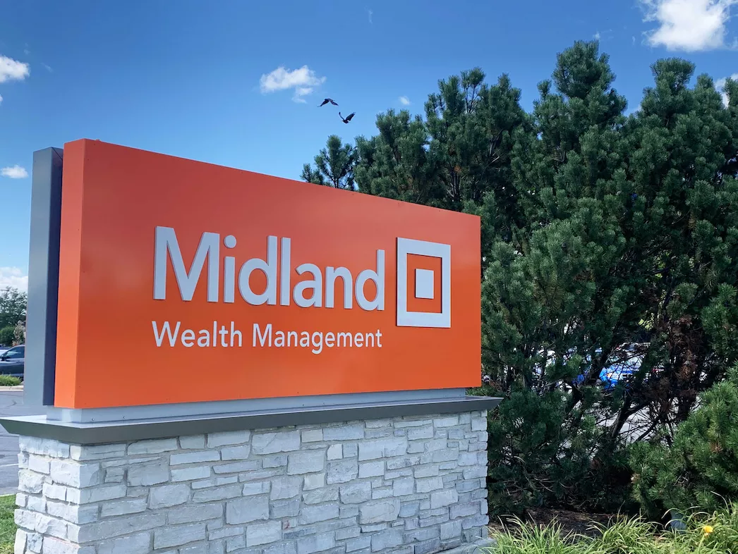 midland wealth management sign against blue sky background